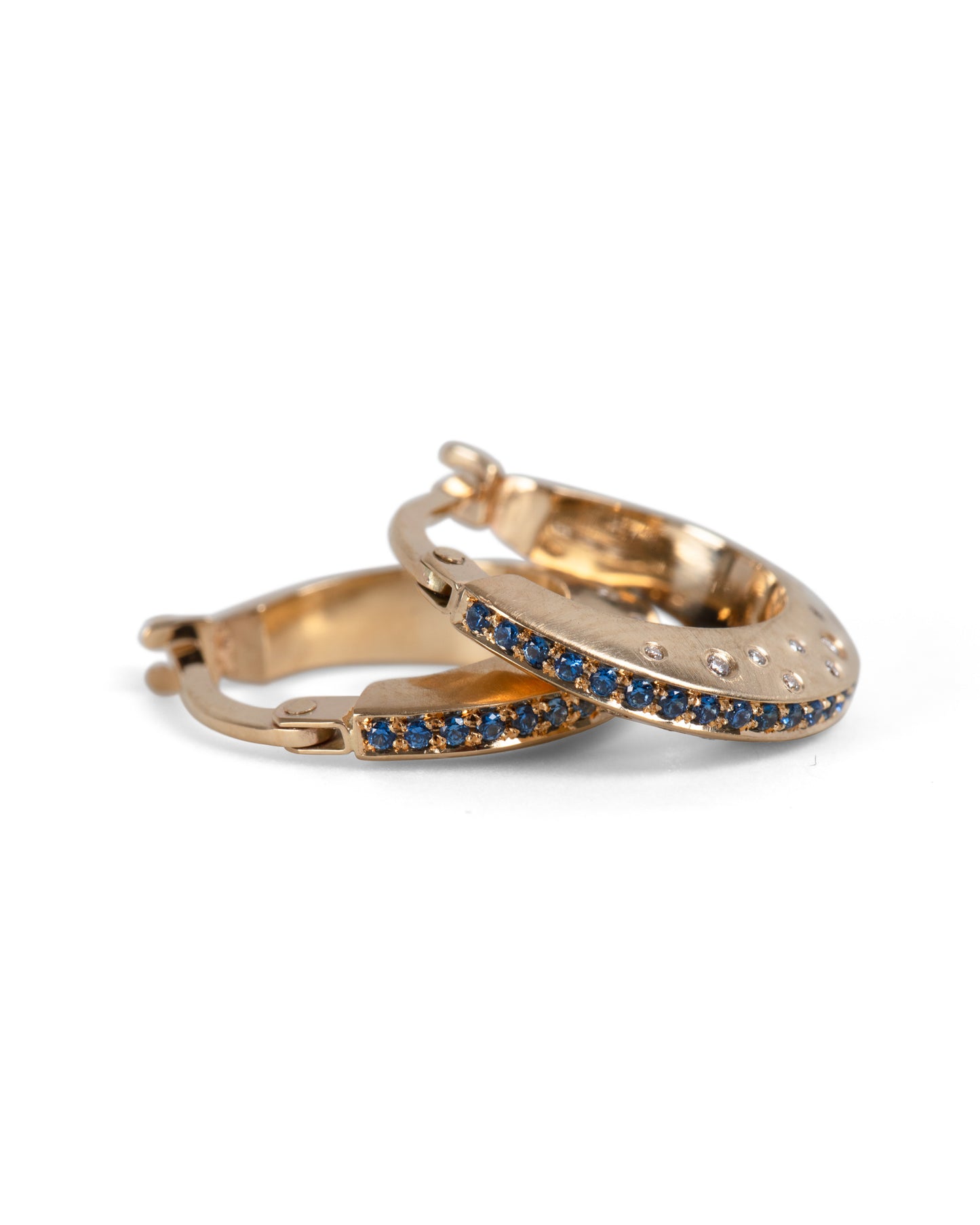 gold knife edge hoop earrings with pavé set blue sapphires