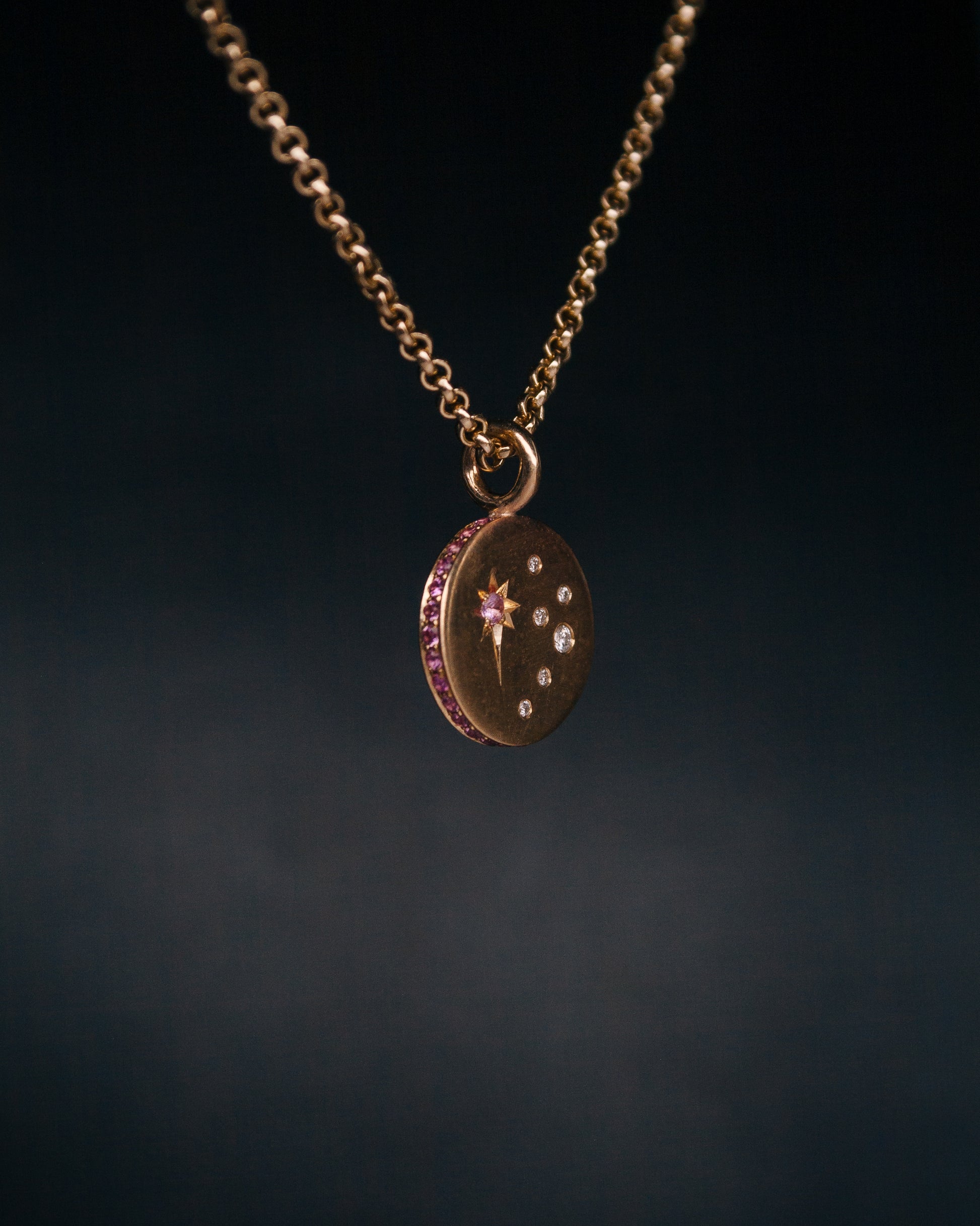 round gold disc sapphire pendant on a chain